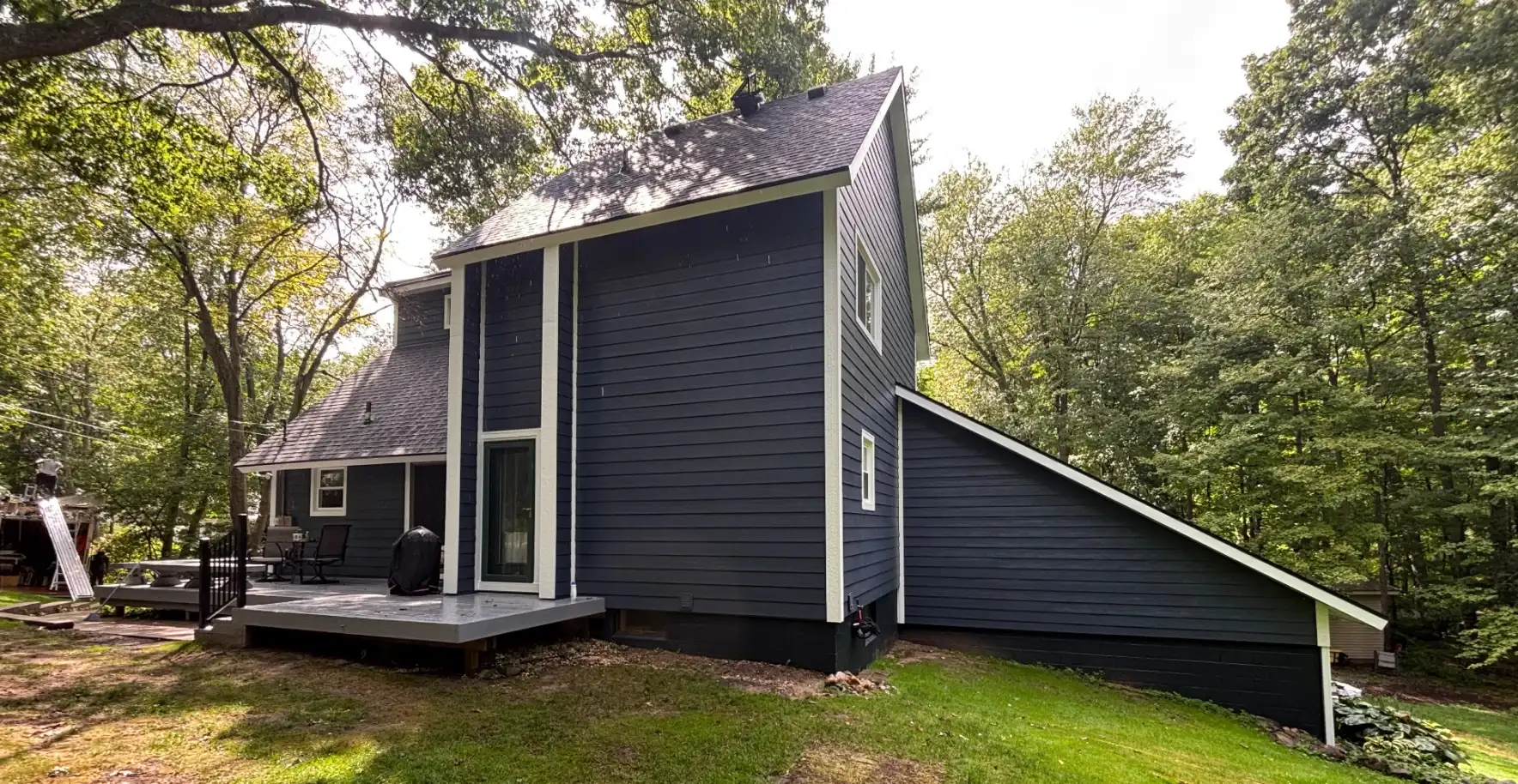 Navy board and batten siding installed by Anchor Siding LLC on a mid-Michigan home