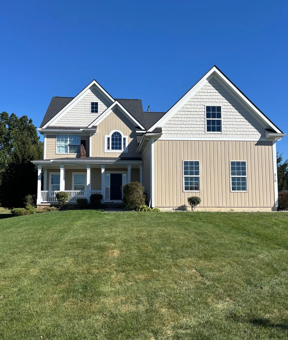 Cream two-story, finished - real Anchor Siding LLC job in mid-Michigan