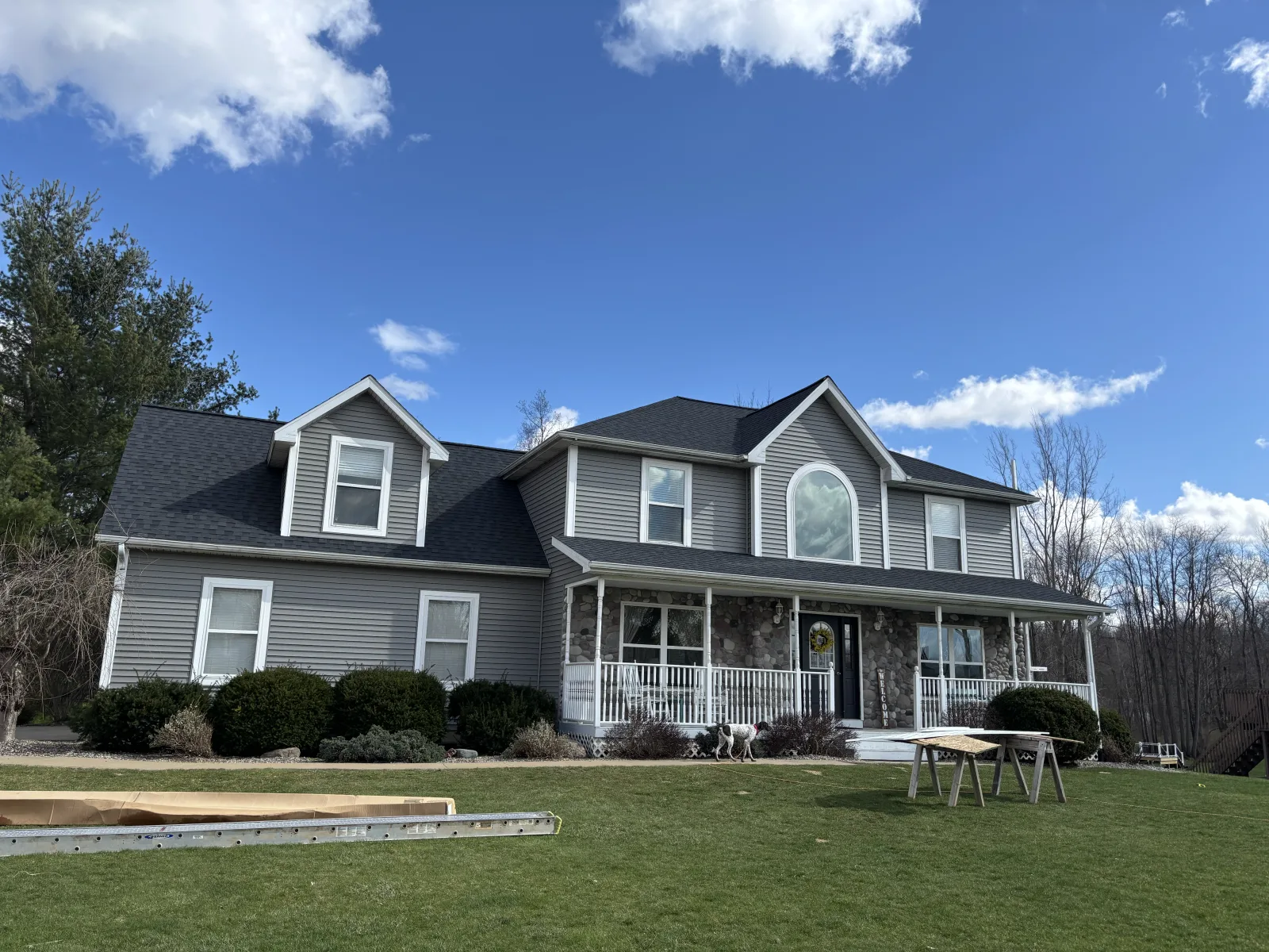 Two-story home with dormers and multiple rooflines finished by Anchor Siding LLC in mid-Michigan