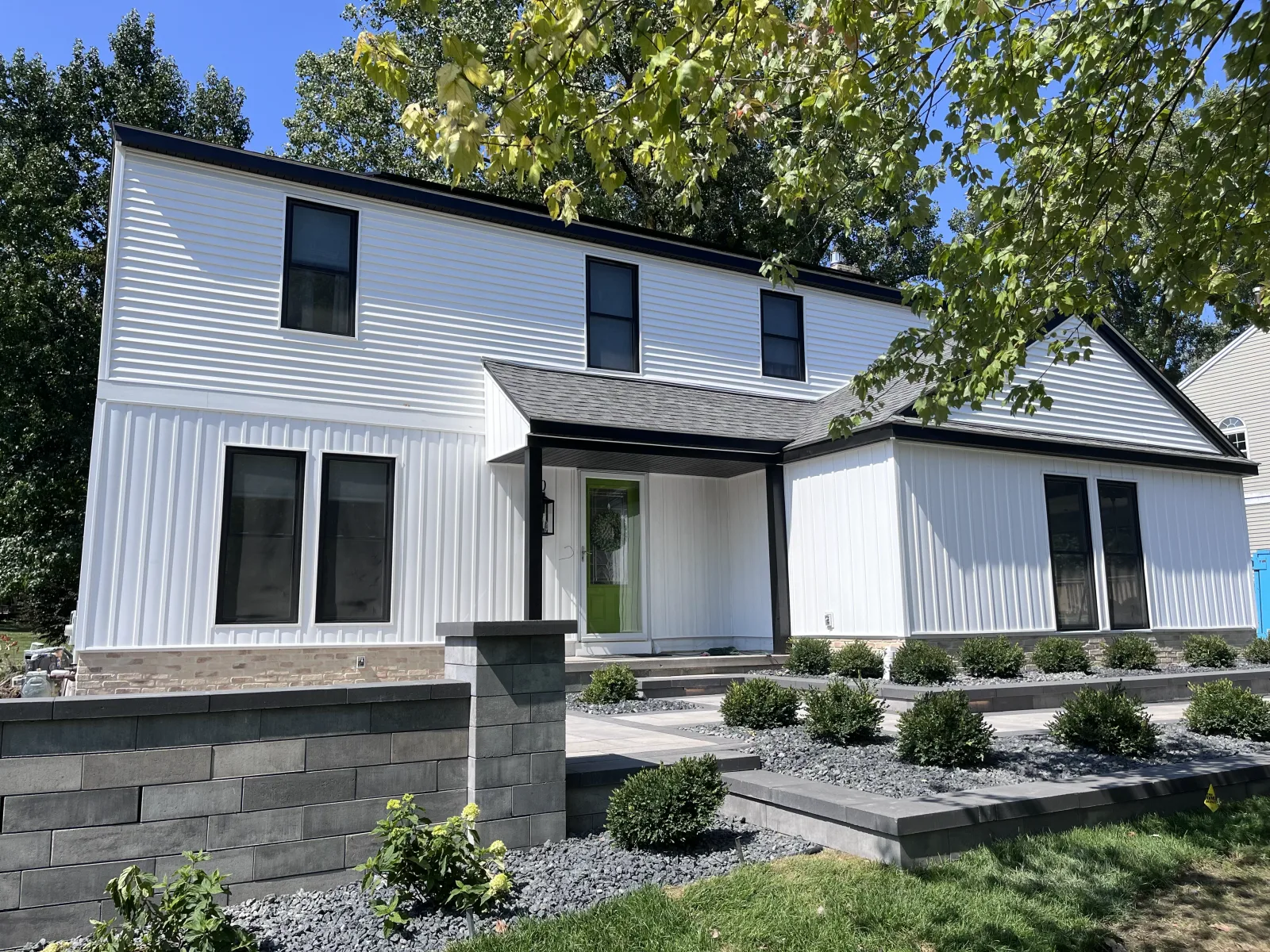 White siding under a bright sky - real Anchor Siding LLC job in mid-Michigan