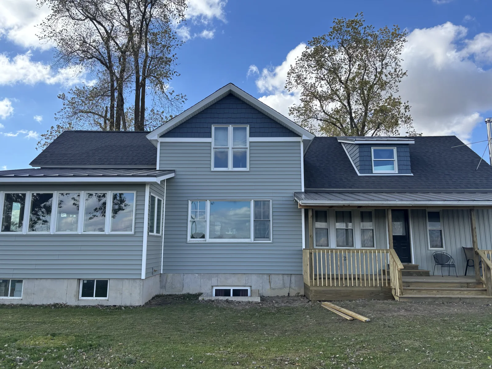 New roof on a blue two-story - real Anchor Siding LLC job in mid-Michigan