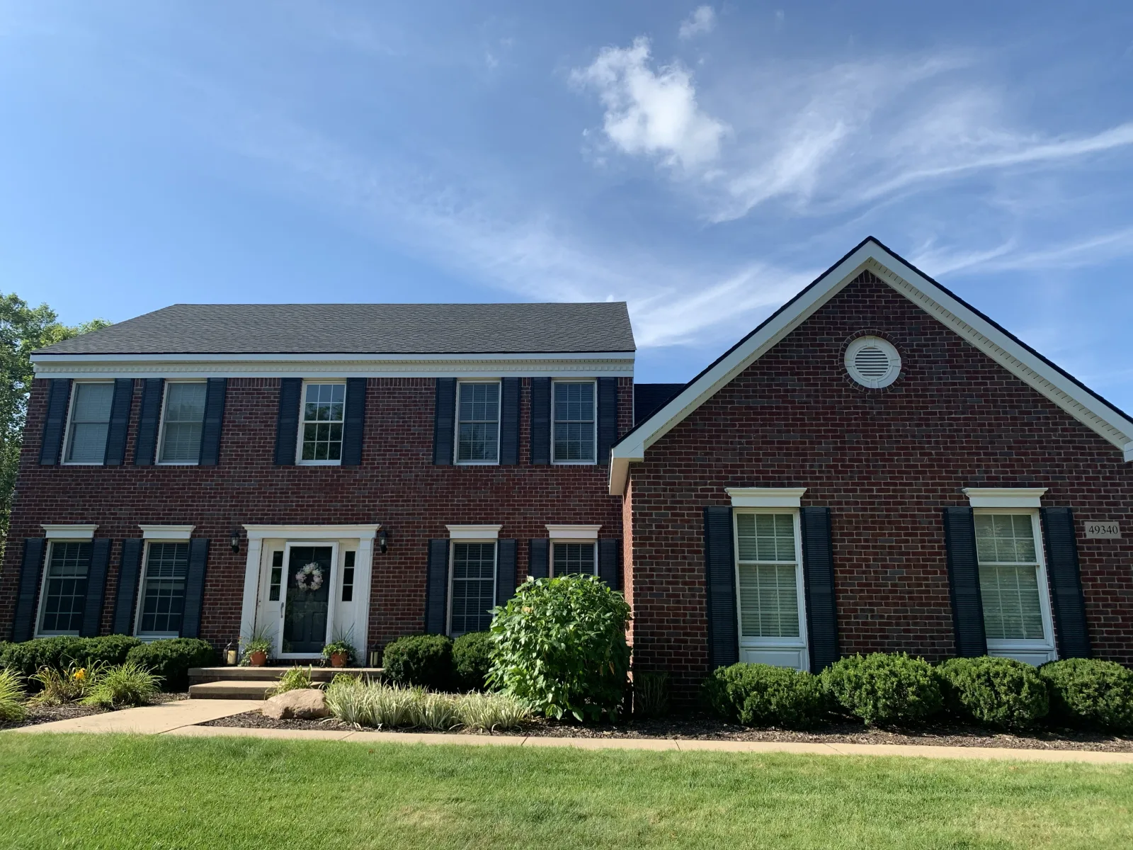 Brick colonial, new siding and windows - real Anchor Siding LLC job in mid-Michigan