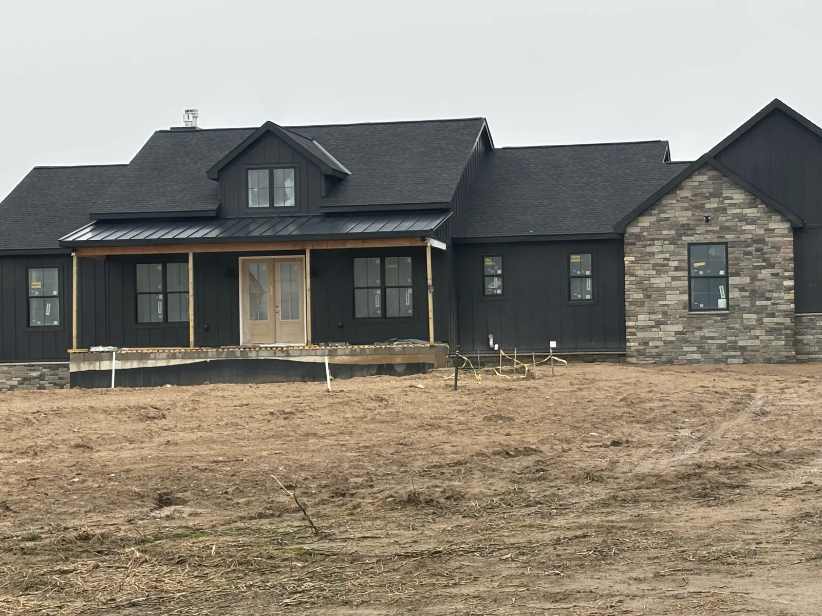 New siding with stone accent - real Anchor Siding LLC job in mid-Michigan