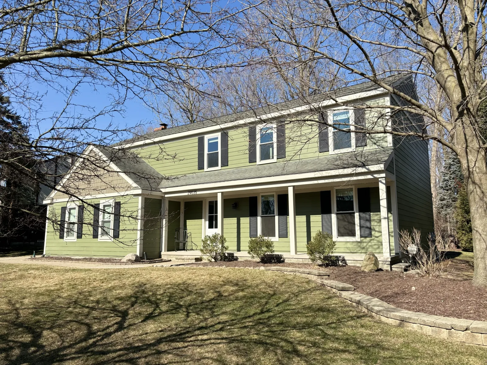 Wood siding repair on a yellow colonial home in mid-Michigan by Anchor Siding LLC