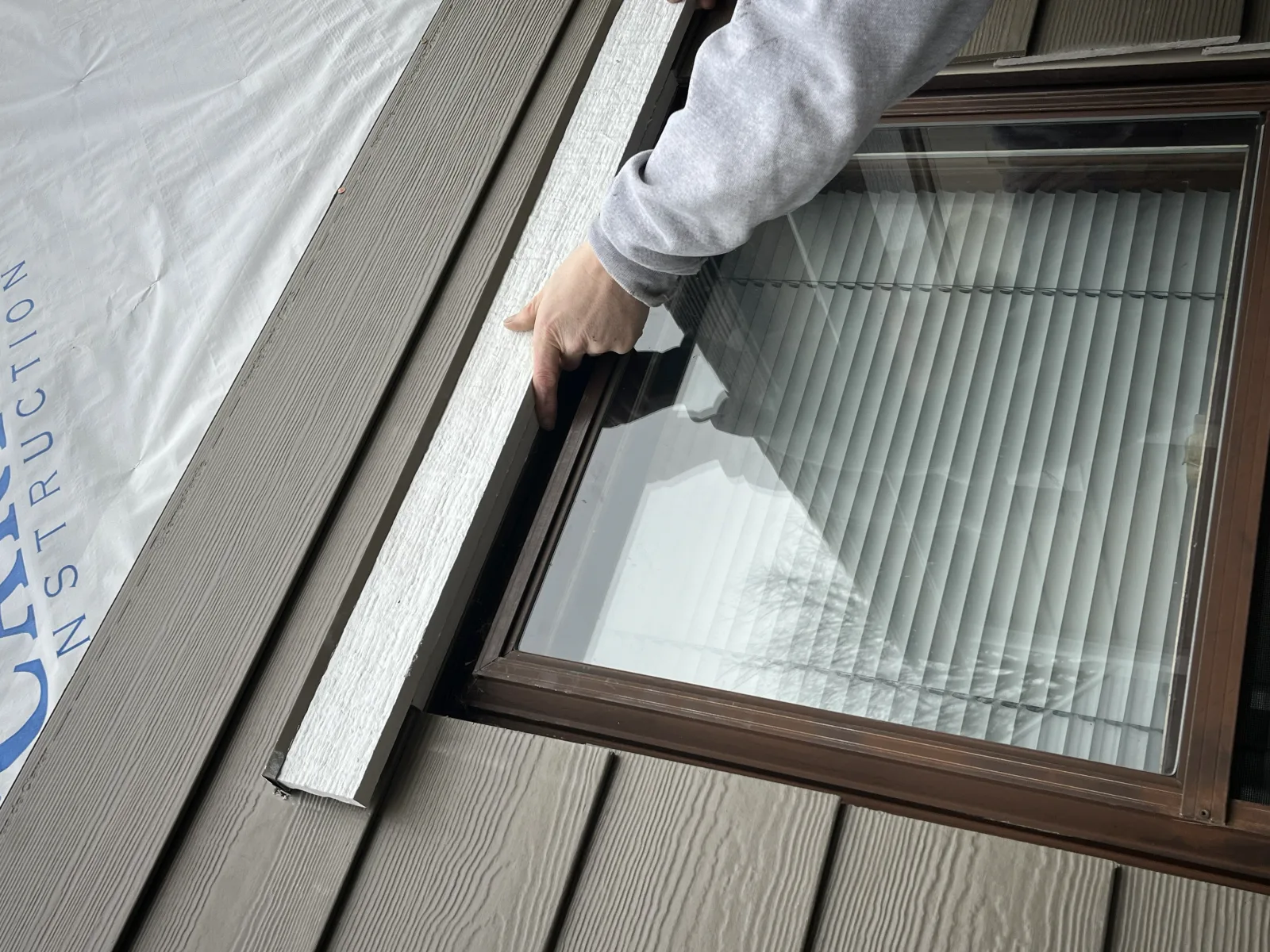Anchor Siding LLC crew doing gutter repair by hand in mid-Michigan